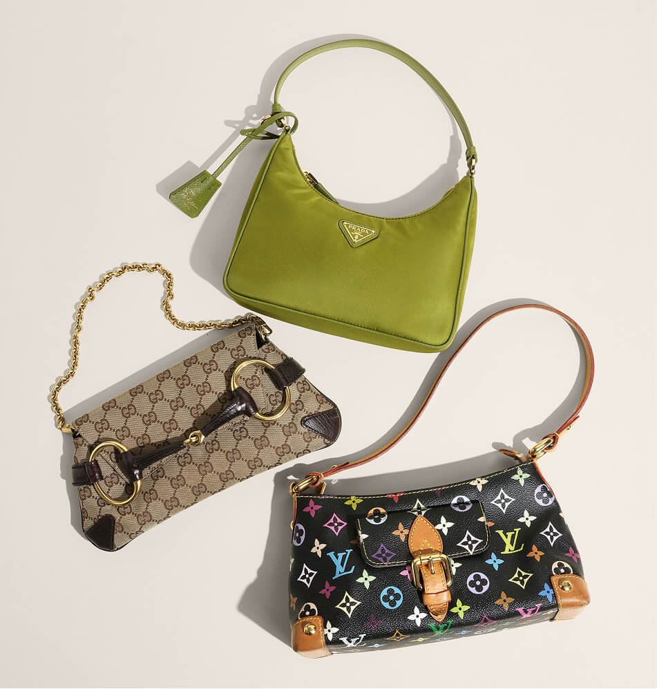 26 three designer handbags arranged on a light beige background a green prada shoulder bag at the top, a beige gucci monogram horsebit clutch with a gold chain on the left, and a black lou